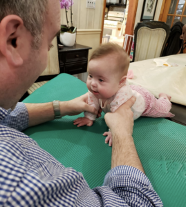 Image of specialist helping a baby using Dynamic Movement Intervention methods